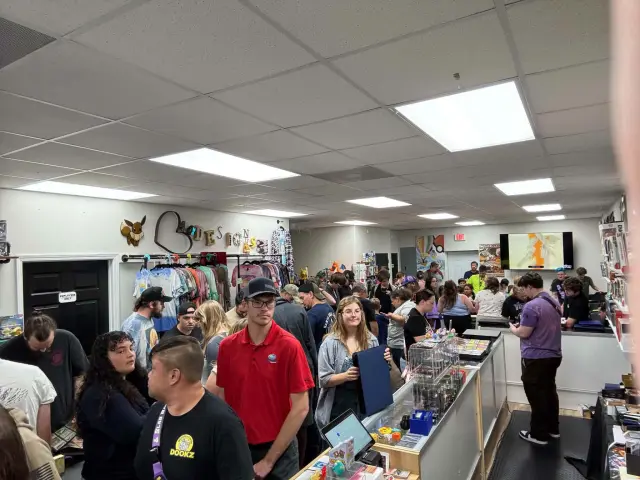 A full house of trainers at the PokeShop 850 counters